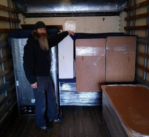 partially loaded moving truck with mover